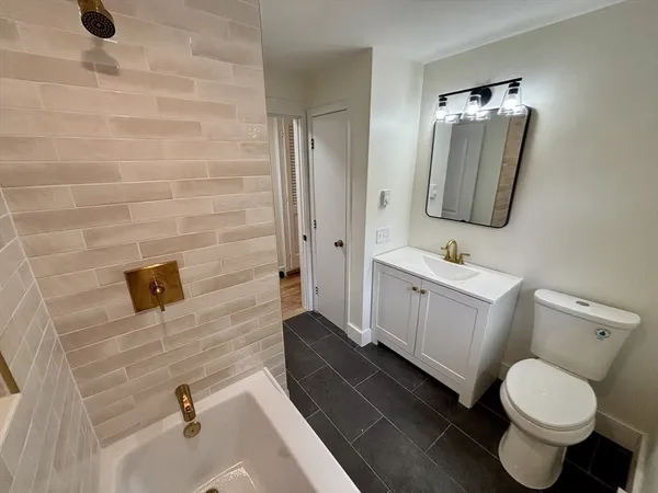 a bath tub sitting next to a white sink