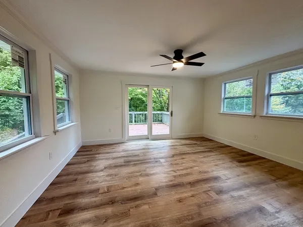 wooden floor in an empty room with a window