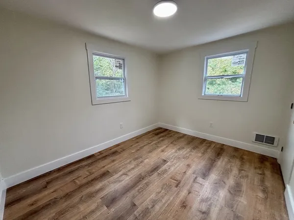 a view of room with window and hardwood floor