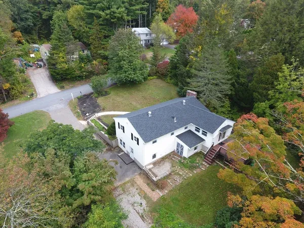 an aerial view of a house with a yard