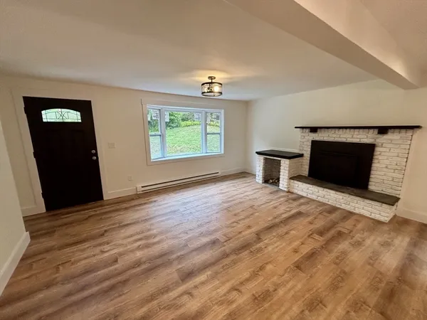 wooden floor fireplace and windows in a room