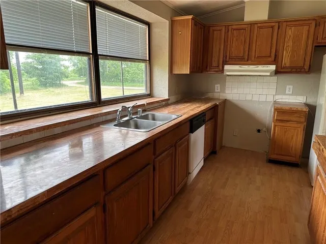 a kitchen with a refrigerator and a sink
