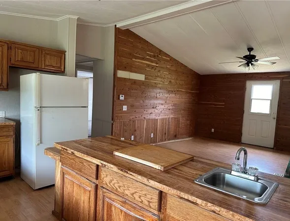 a living room with stainless steel appliances furniture and a large window