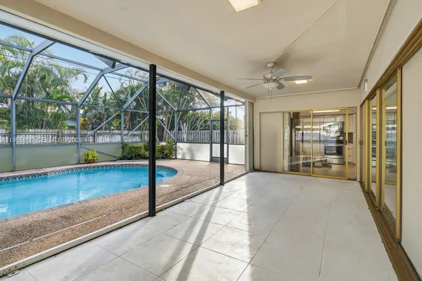 a view of hallway with a floor to ceiling window and an outdoor view