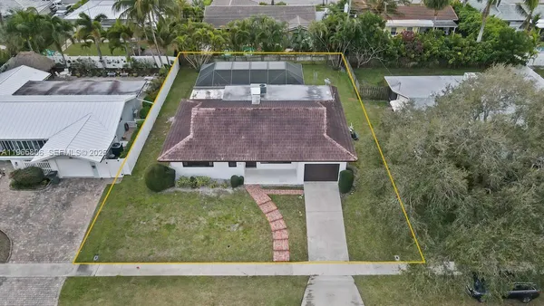 an aerial view of a house with a yard