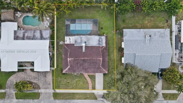 an aerial view of a house with garden space and a car park