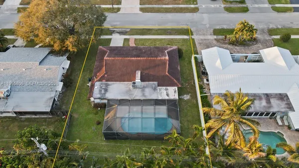 an aerial view of a house with a yard
