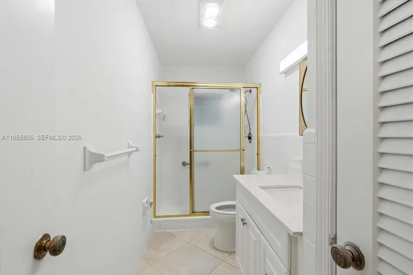 a bathroom with a sink mirror and toilet