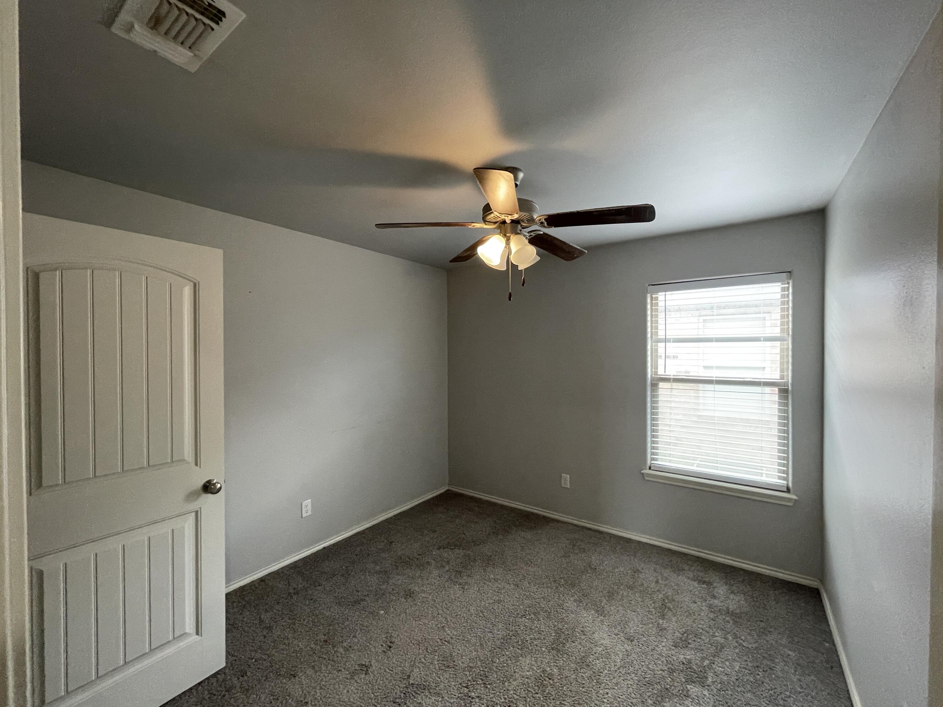 1012 Preston Trail Wolfforth, TX 79382 - Photo 15 of 21 a view of a livingroom with a ceiling fan and window
