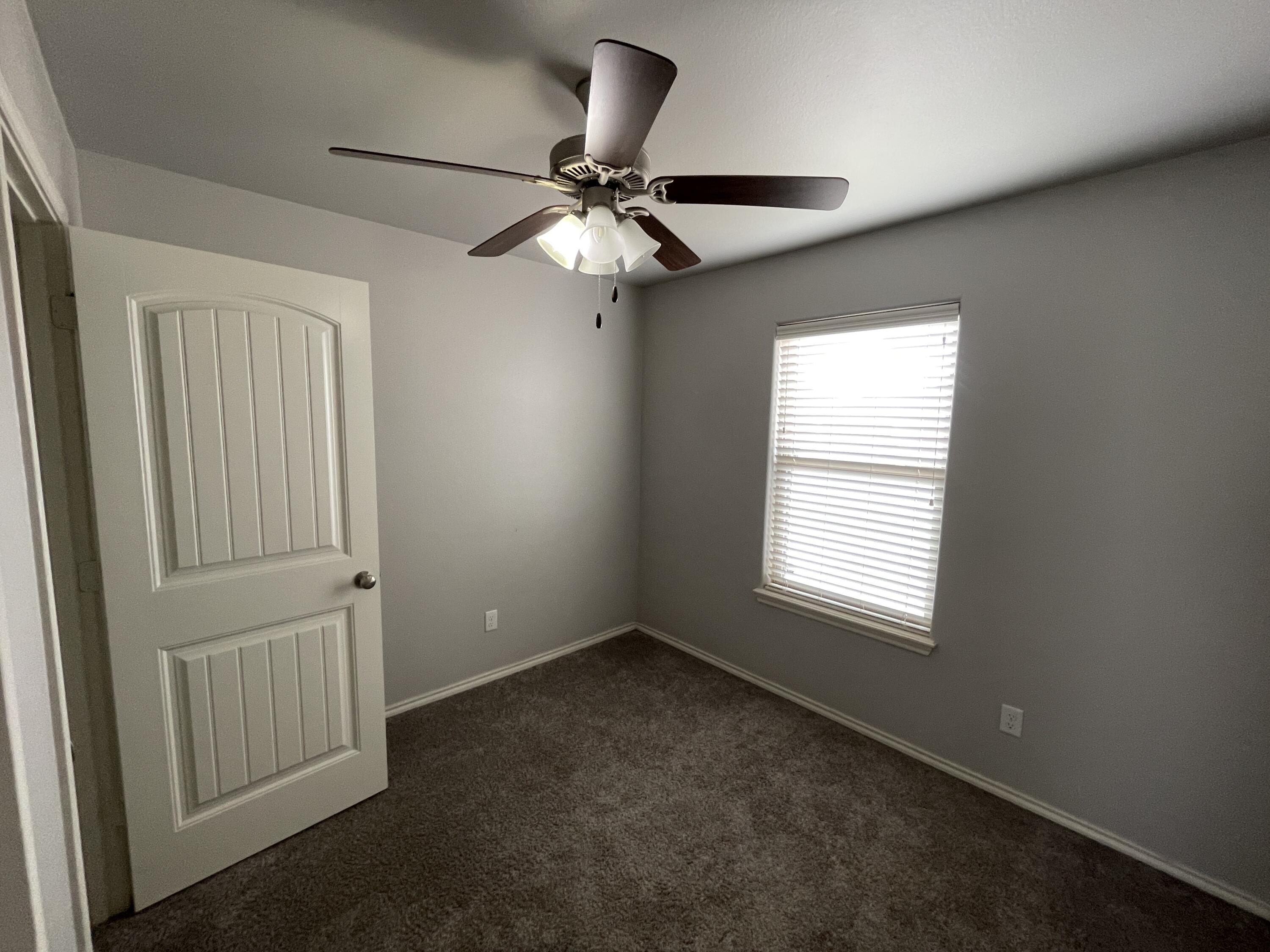1012 Preston Trail Wolfforth, TX 79382 - Photo 20 of 21 an empty room with windows and fan