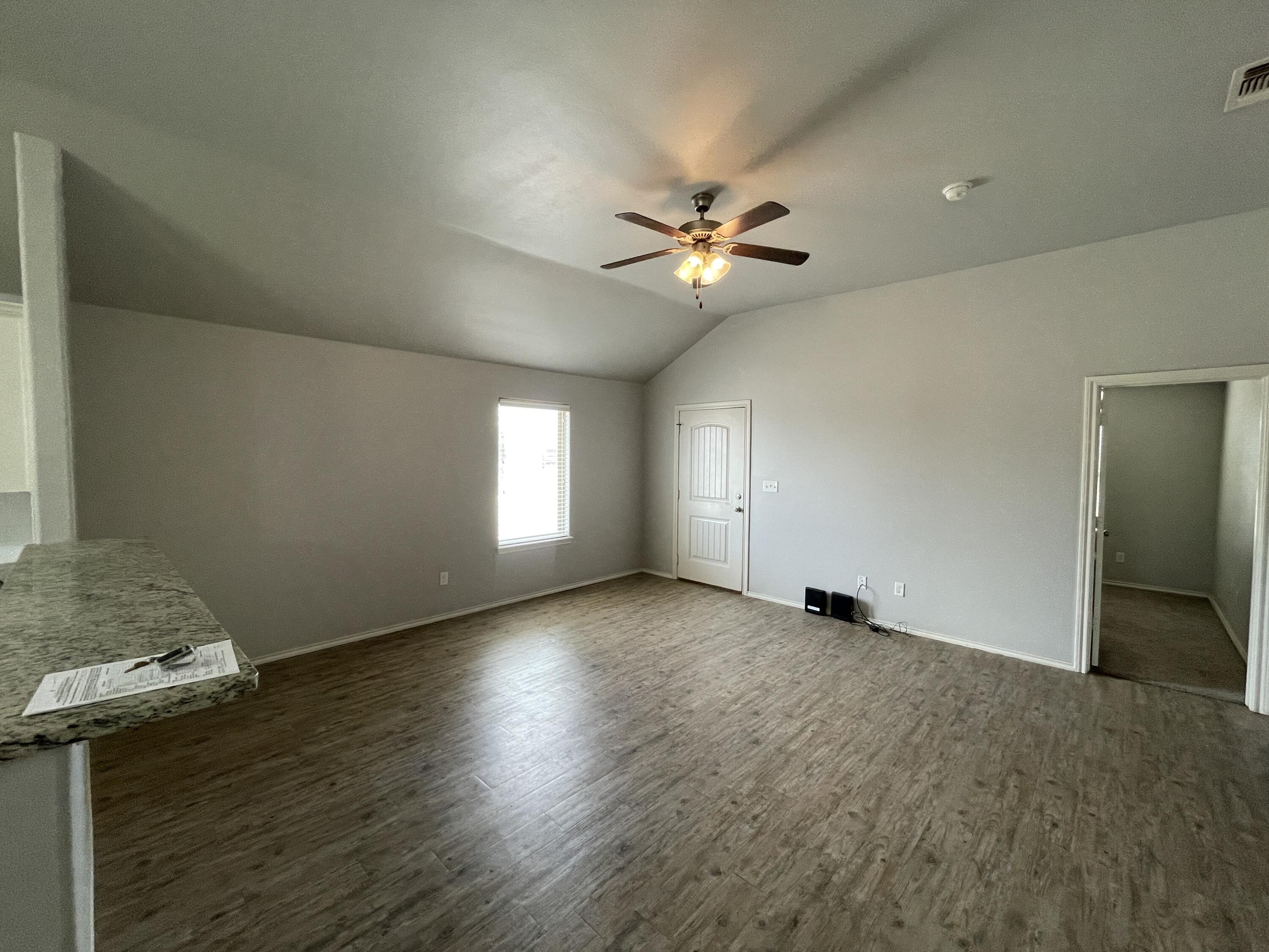 1012 Preston Trail Wolfforth, TX 79382 - Photo 3 of 21 wooden floor in an empty room with a window