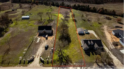 a aerial view of a house with a yard