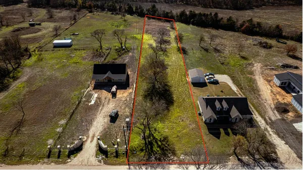 a aerial view of a house with a yard