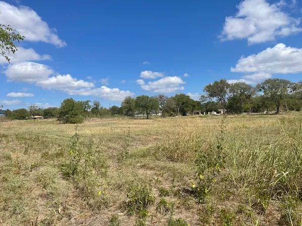 a view of lake with sunset in background