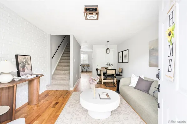 a living room with furniture and wooden floor