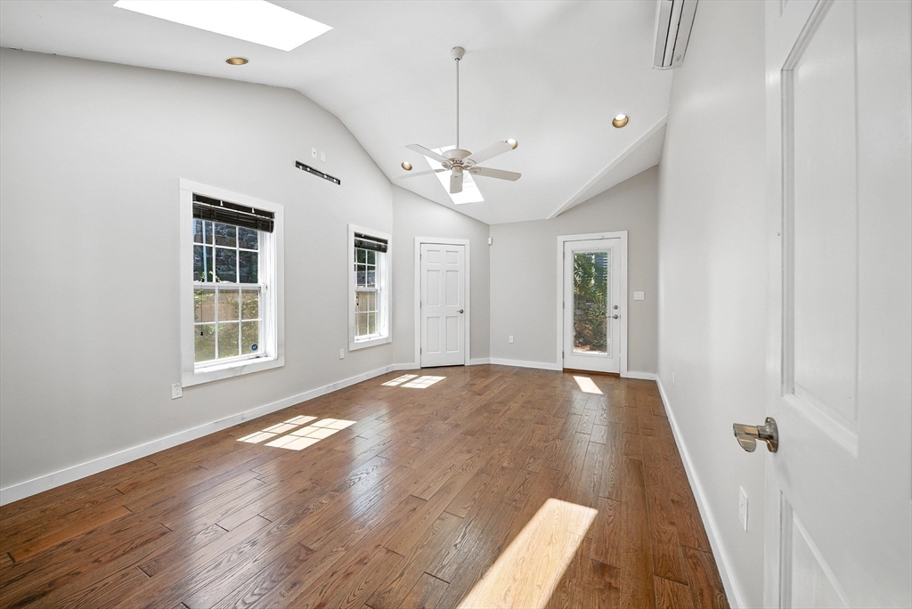 13 Oak Street Salem, MA 01970 - Photo 11 of 42 a view of an empty room with a window and wooden floor