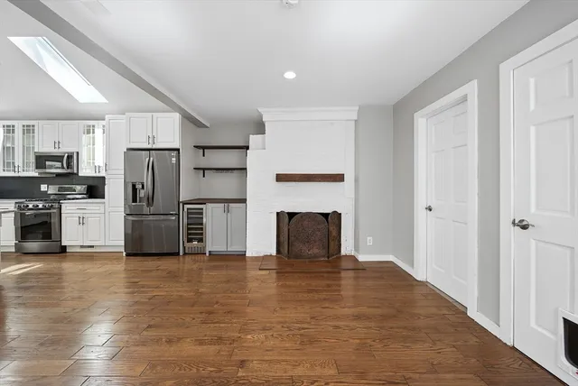 a kitchen with granite countertop a refrigerator and a stove top oven