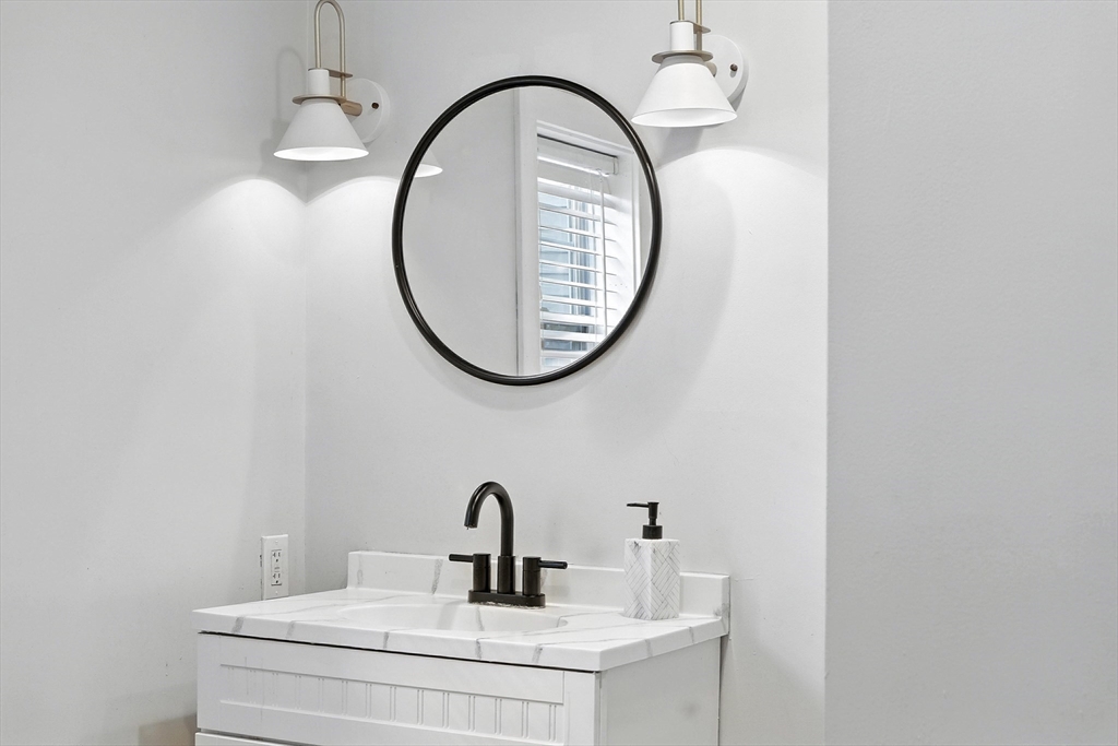 13 Oak Street Salem, MA 01970 - Photo 15 of 42 a bathroom with a sink and a mirror