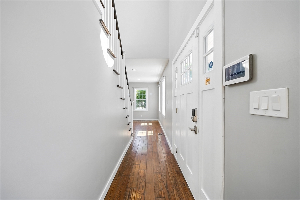 13 Oak Street Salem, MA 01970 - Photo 16 of 42 a view of a hallway with wooden floor and staircase