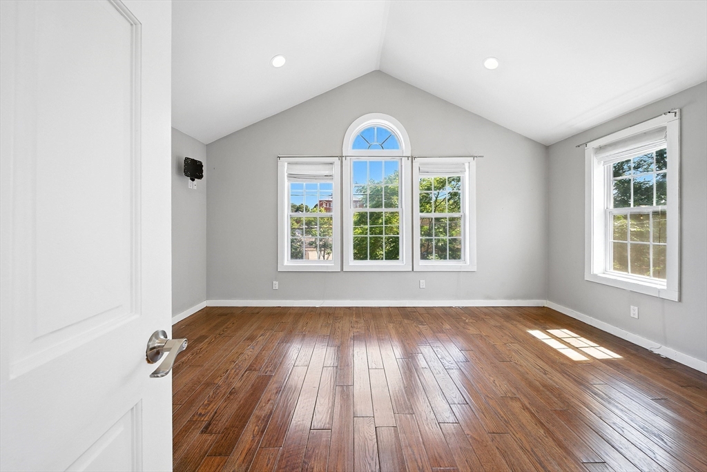 13 Oak Street Salem, MA 01970 - Photo 20 of 42 an empty room with wooden floor and windows