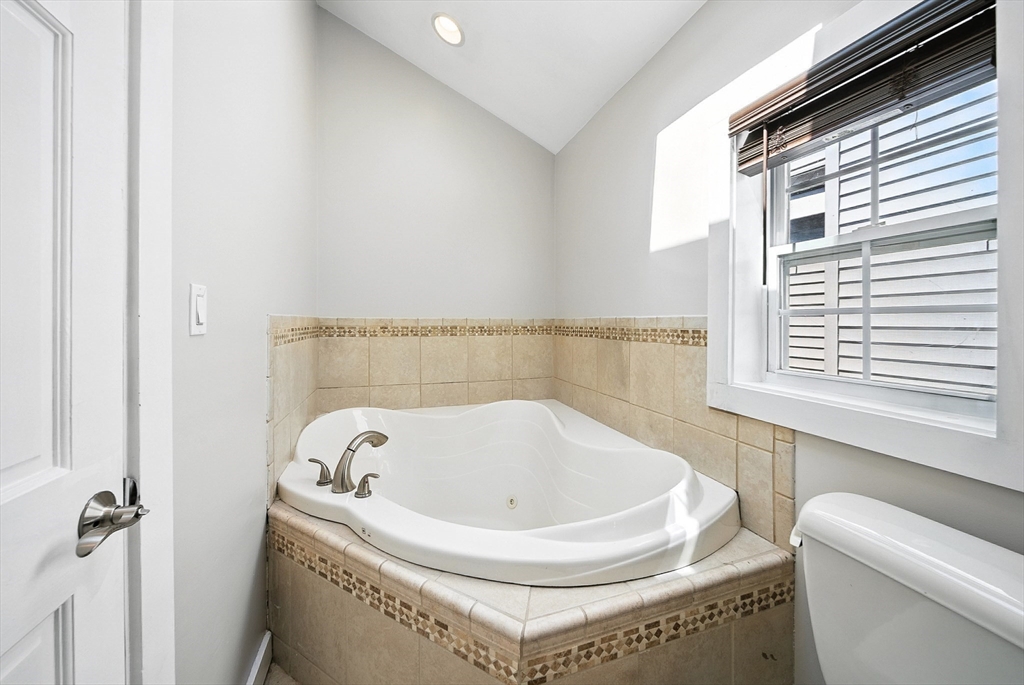 13 Oak Street Salem, MA 01970 - Photo 25 of 42 a bathroom with a bathtub and a window