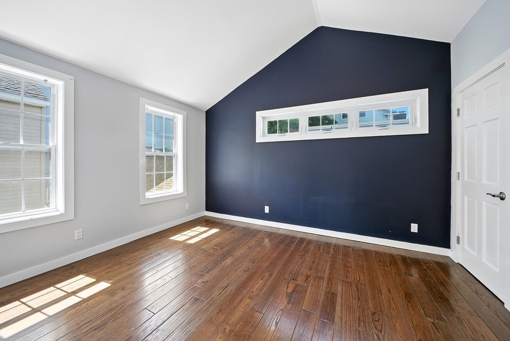 13 Oak Street Salem, MA 01970 - Photo 26 of 42 an empty room with wooden floor and windows