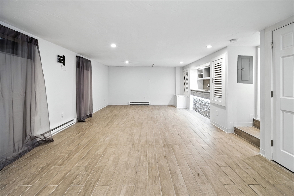 13 Oak Street Salem, MA 01970 - Photo 31 of 42 a view of empty room with wooden floor and window