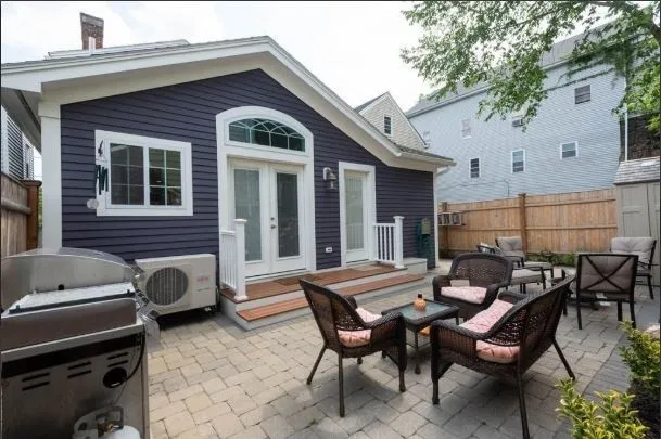 a backyard of a house with outdoor seating
