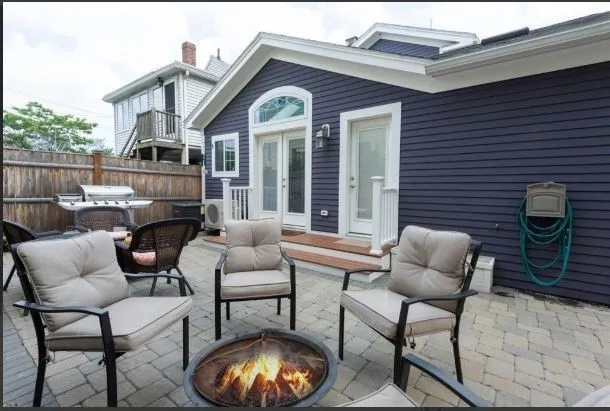 a view of a house with a chairs and a table in a patio