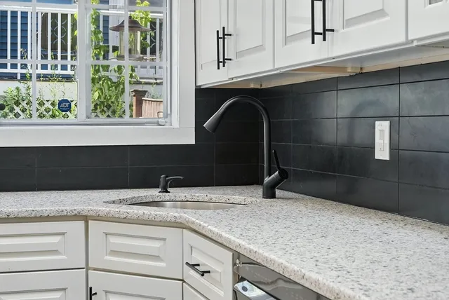 a kitchen with a sink and a window