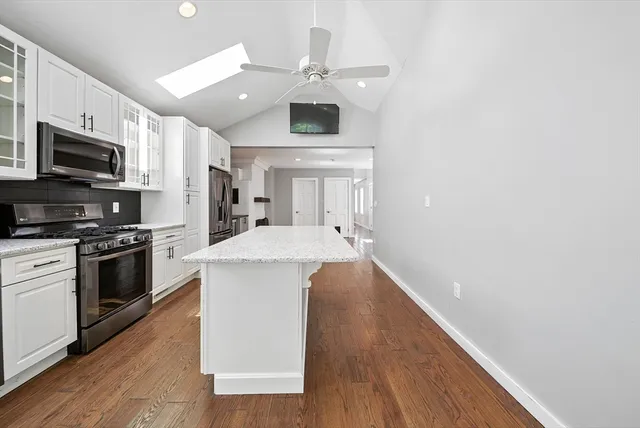 a kitchen with a sink and steel appliances