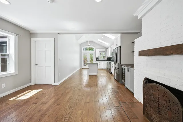 a view of a living room with furniture and wooden floor