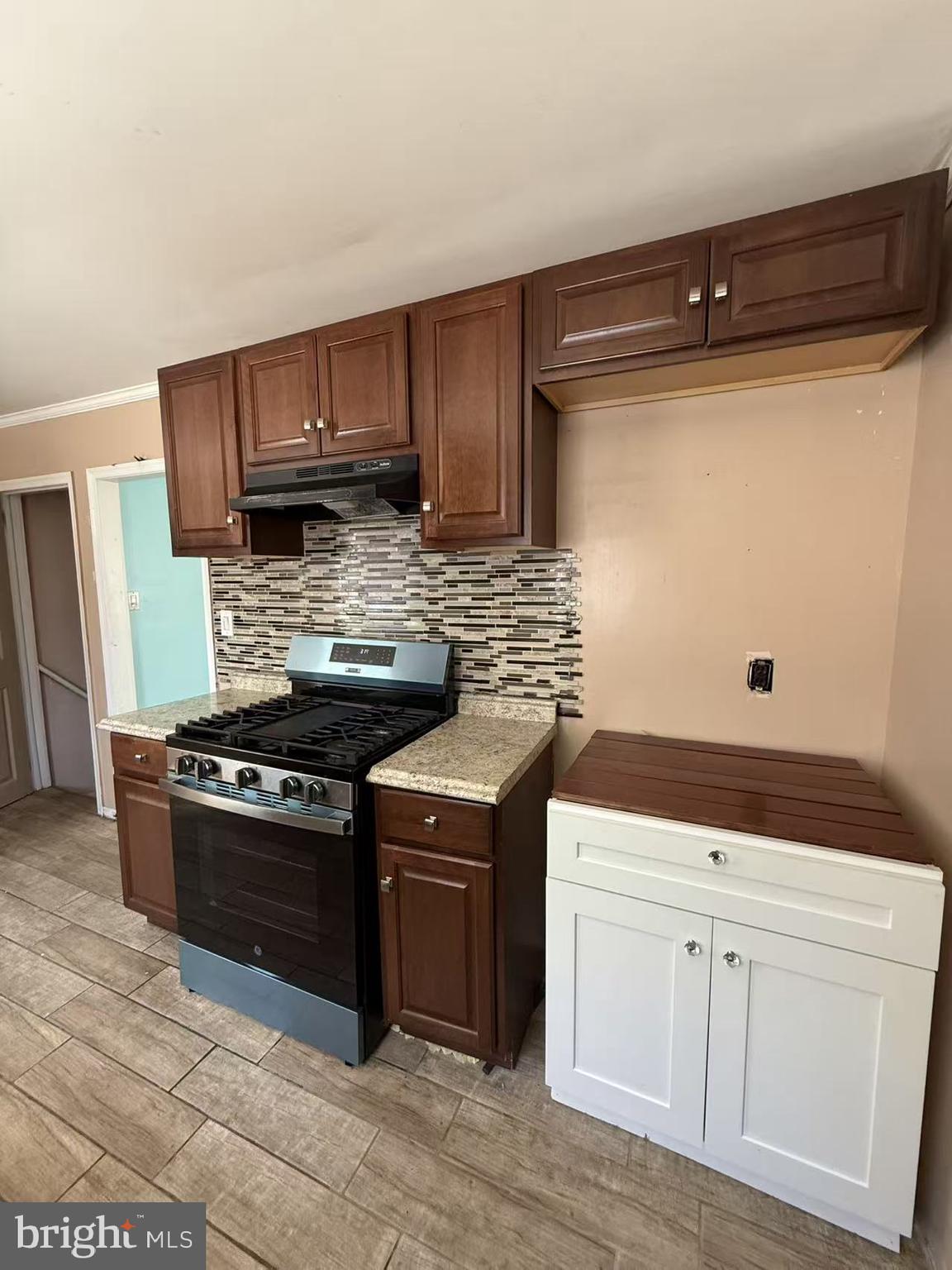7640 Fairfield Street Philadelphia, PA 19152 - Photo 12 of 24 a kitchen with white cabinets and black appliances