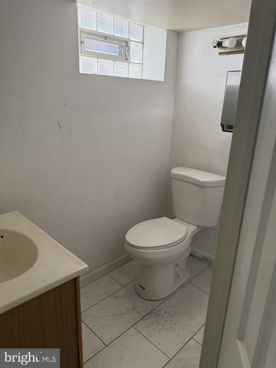 7640 Fairfield Street Philadelphia, PA 19152 - Photo 23 of 24 a white toilet sitting next to a white sink and vanity