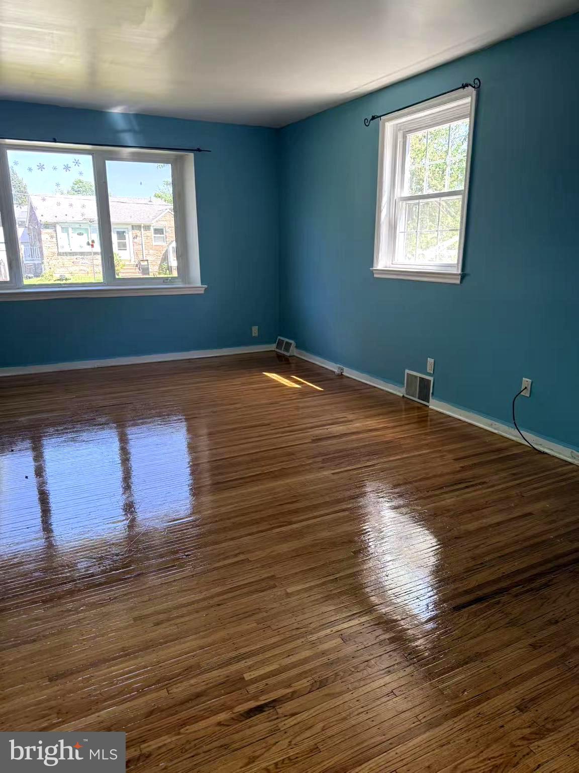 7640 Fairfield Street Philadelphia, PA 19152 - Photo 5 of 24 an empty room with wooden floor and windows