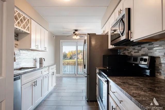 a kitchen with stainless steel appliances granite countertop a stove and a sink