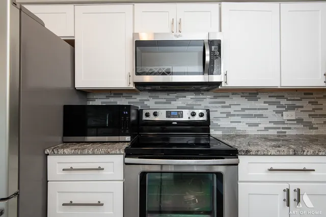 a stove top oven sitting inside of a kitchen