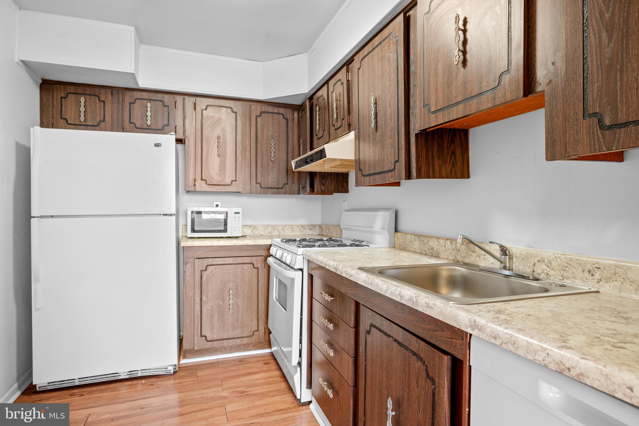 5101 8th Road South, Unit 407 Arlington, VA 22204 - Photo 3 of 26 a kitchen with stainless steel appliances granite countertop a sink stove and refrigerator