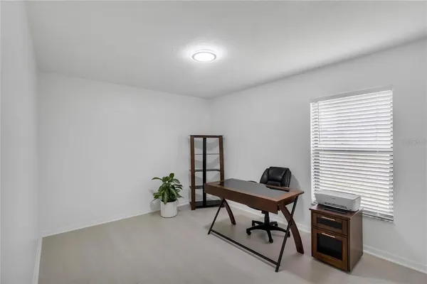a bedroom with a bed and a desk