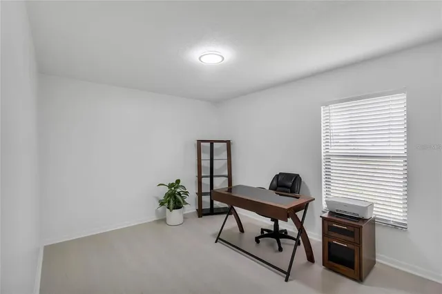 a bedroom with a bed and a desk
