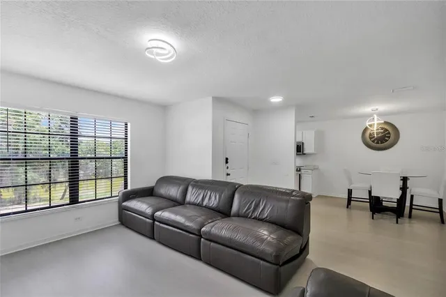 a kitchen with stainless steel appliances a sink a stove a microwave and refrigerator