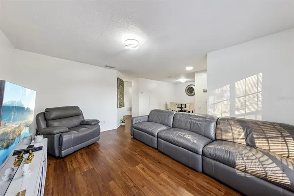 a living room with furniture and a floor to ceiling window