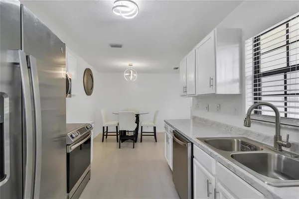 a kitchen with a sink appliances and cabinets