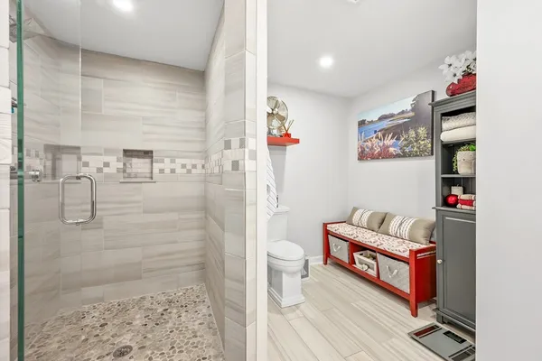 a bathroom with a toilet and a shower