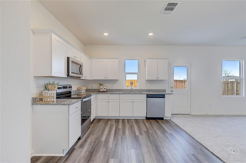 1709 Chapel Hill Road Princeton, TX 75407 - Photo 11 of 25 a kitchen with sink a microwave and cabinets