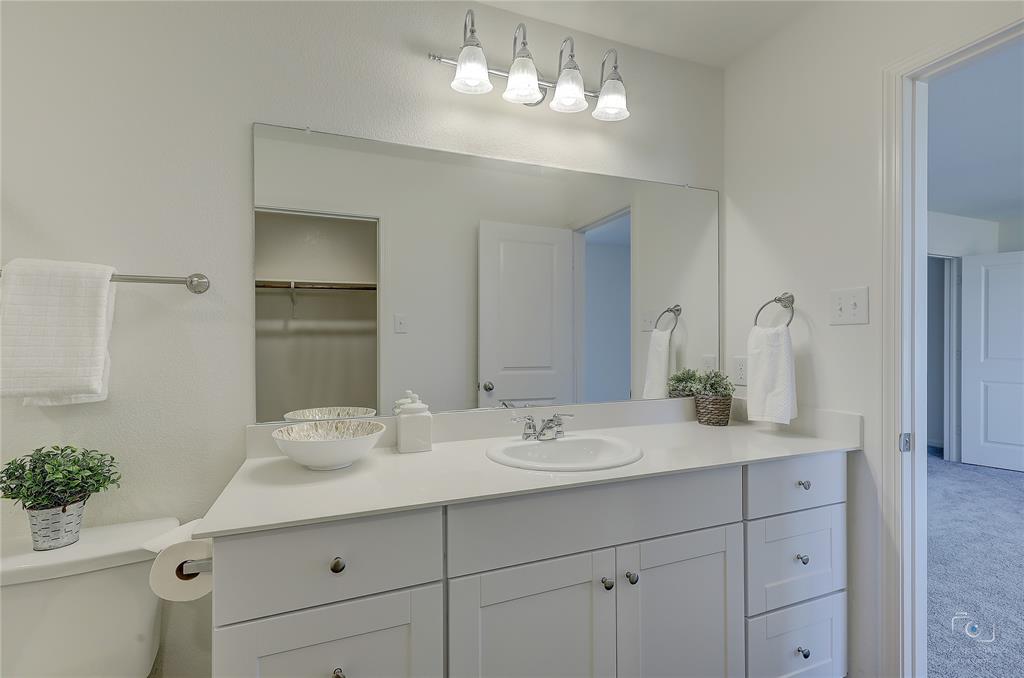 1709 Chapel Hill Road Princeton, TX 75407 - Photo 17 of 25 a bathroom with a sink vanity granite and toilet