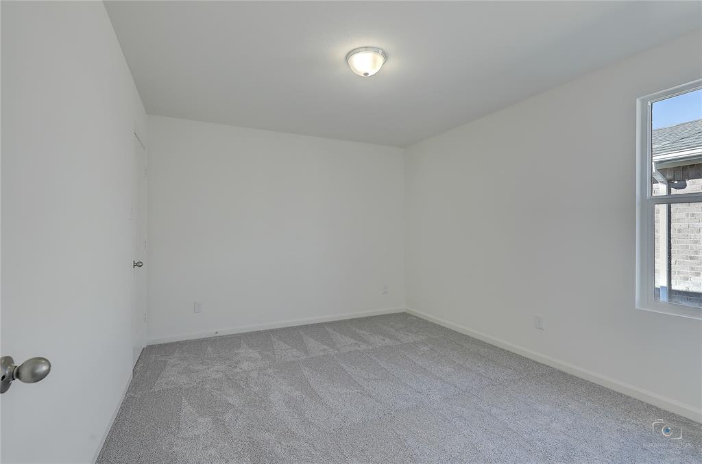 1709 Chapel Hill Road Princeton, TX 75407 - Photo 18 of 25 an empty room with windows