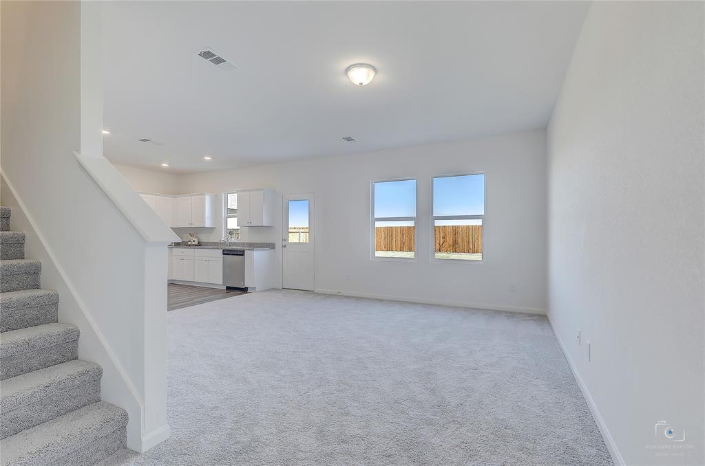 1709 Chapel Hill Road Princeton, TX 75407 - Photo 8 of 25 an empty room with windows and pillars in it