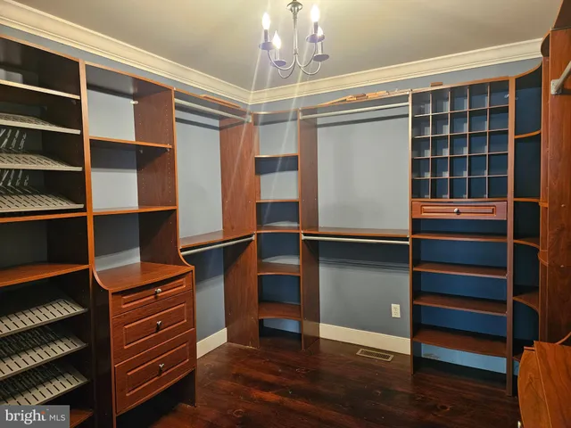a view of a room with a ceiling fan and a window