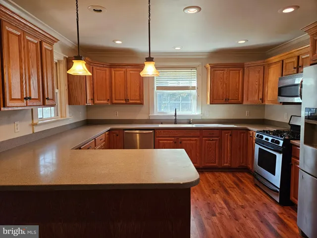 a kitchen with a sink a window and cabinets